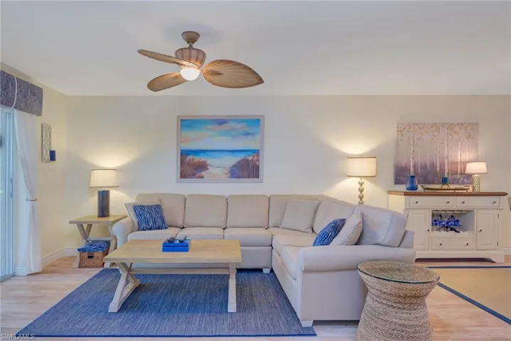 Living room with ceiling fan and light wood-type flooring