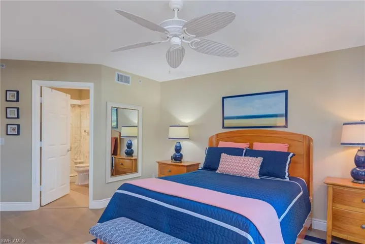 Bedroom featuring ensuite bathroom, ceiling fan, and light hardwood / wood-style floors