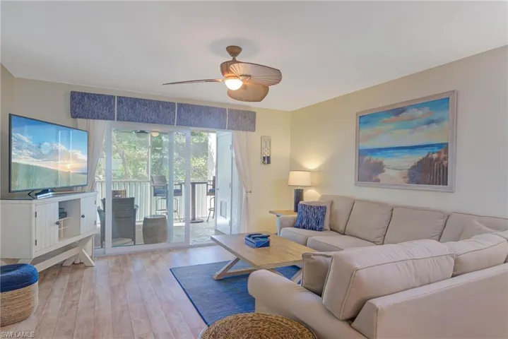 Living room featuring ceiling fan and light hardwood / wood-style flooring