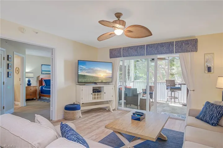 Living room with light wood-type flooring and ceiling fan