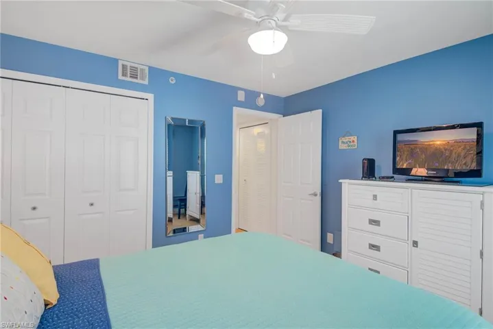 Bedroom featuring ceiling fan and a closet