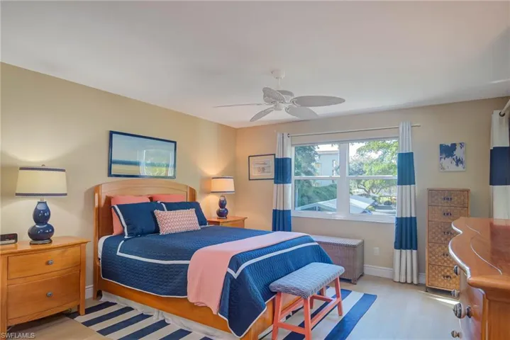 Bedroom featuring radiator heating unit, light hardwood / wood-style floors, and ceiling fan