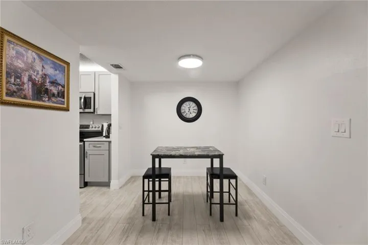 Dining space featuring light wood-type flooring and baseboards