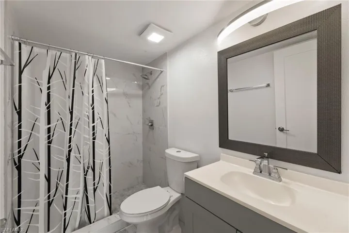 Full bathroom featuring a shower stall and vanity
