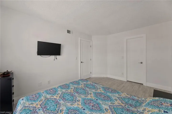 Bedroom featuring light wood-style flooring and a textured ceiling