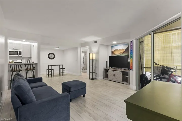 Living room with light wood-style floors and baseboards