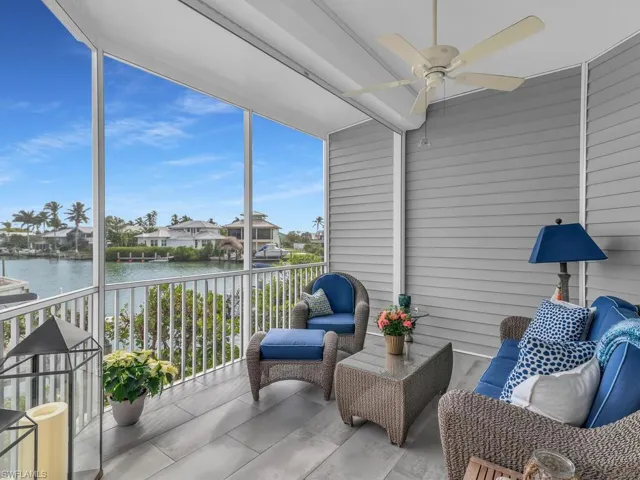 Sunroom with ceiling fan, a water view, and plenty of natural light