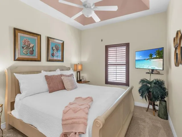Carpeted bedroom with ceiling fan