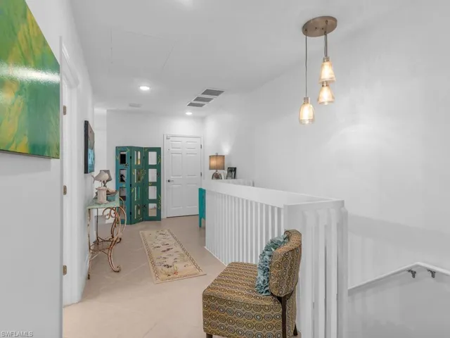 Hall featuring light tile patterned flooring