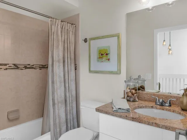 Full bathroom with shower / bath combo, toilet, and vanity