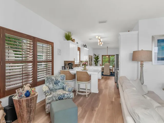 Living room featuring light hardwood / wood-style floors, sink, and a wealth of natural light