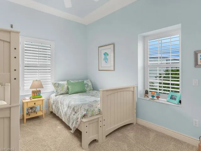 Bedroom featuring ceiling fan and light colored carpet