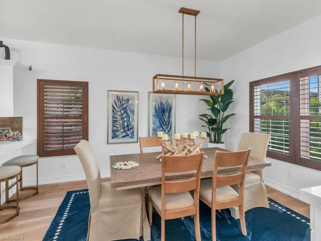 Dining space featuring light hardwood / wood-style flooring and an inviting chandelier
