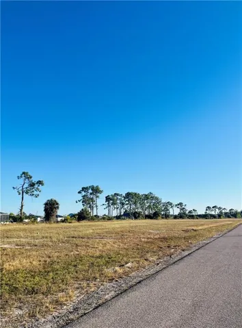View of asphalt road with a view of rural / pastoral area