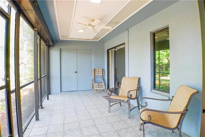 Sunroom featuring a ceiling fan