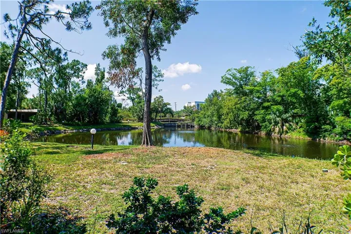 View of grassy yard with a water view
