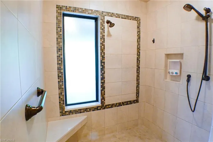 Full bath with a tile shower