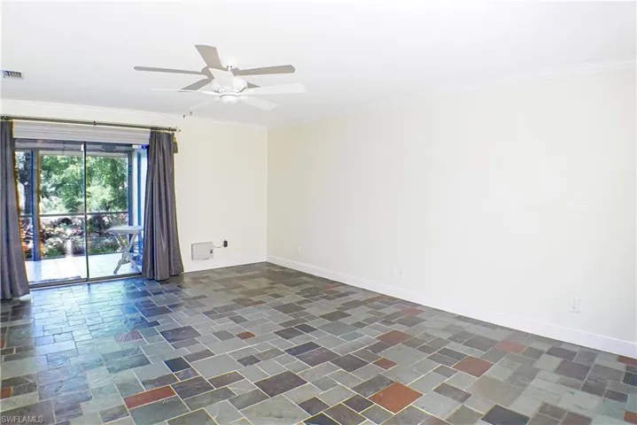 Unfurnished room with a ceiling fan and crown molding