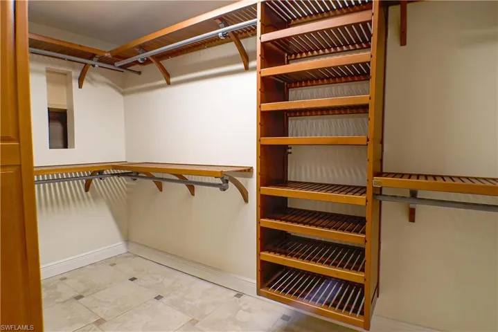 Walk in closet with light tile patterned floors