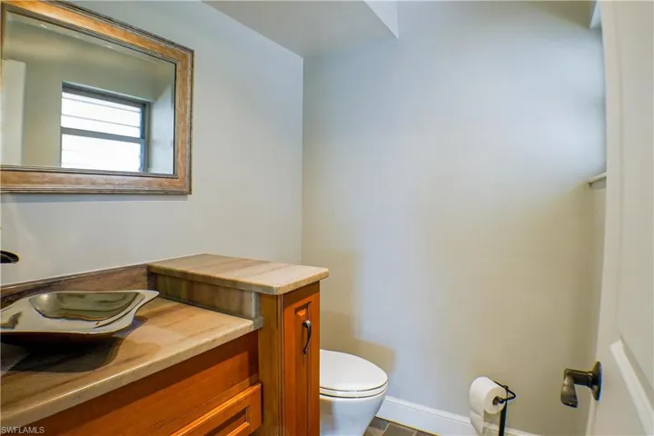 Half bathroom with toilet and vanity