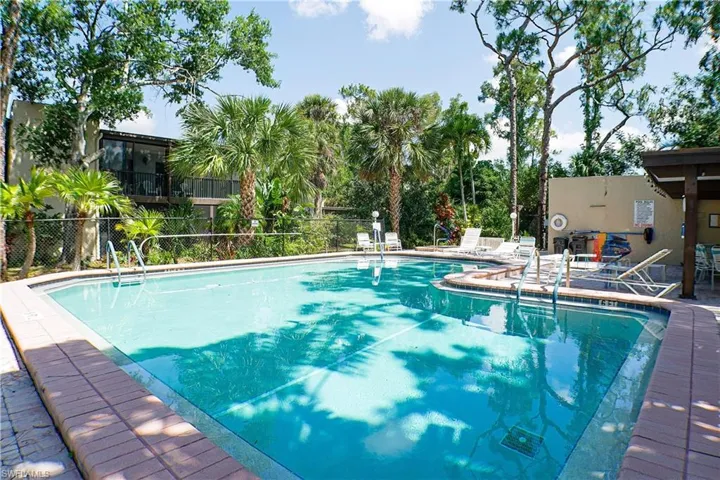 Community pool with a patio