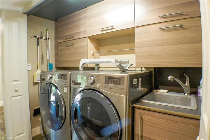 Laundry area with washing machine and clothes dryer