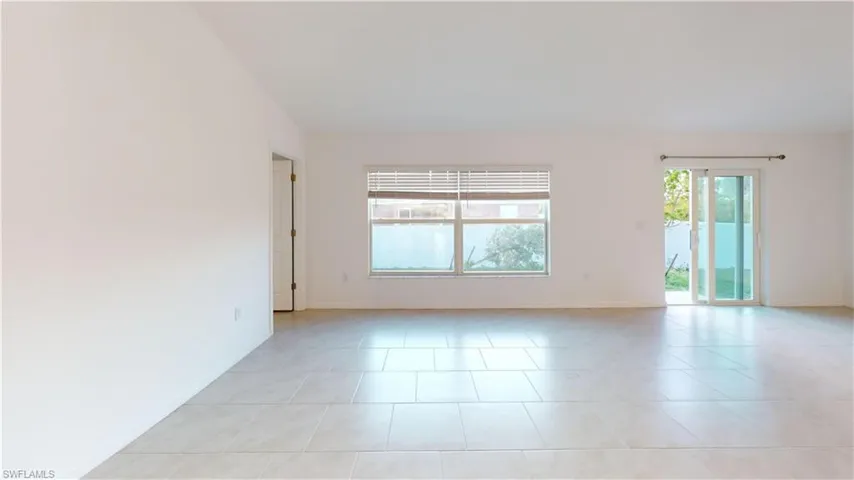 Spacious interior featuring light-colored tile flooring throughout