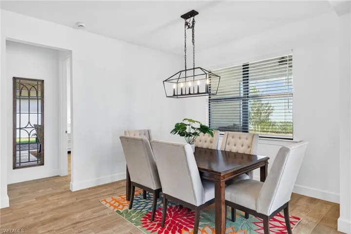 Dining area with light wood finished floors and a chandelier
