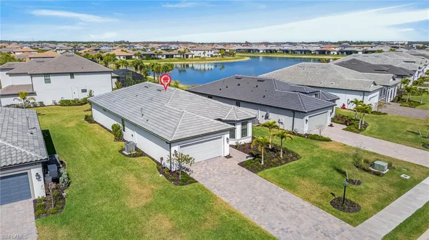 Aerial perspective of suburban area featuring a nearby body of water