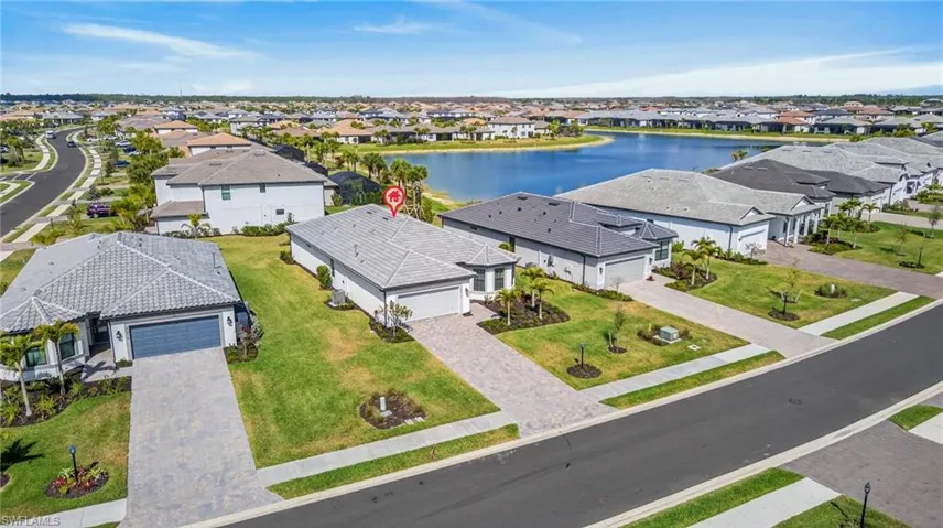 Aerial perspective of suburban area featuring a nearby body of water