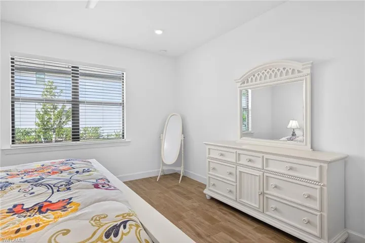 Bedroom with light wood-style floors and recessed lighting