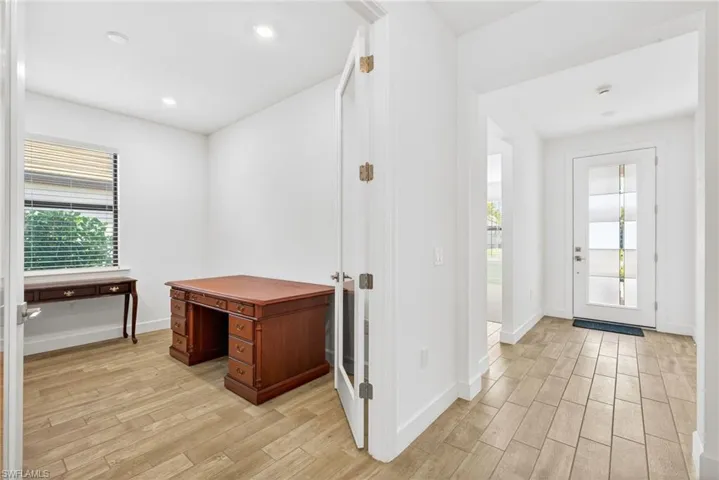 Foyer entrance featuring wood finish floors, plenty of natural light, and recessed lighting