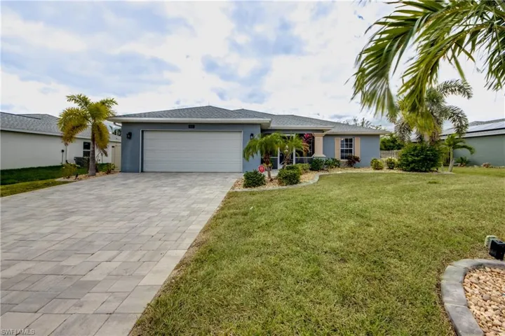 Ranch-style house with a garage and a front yard