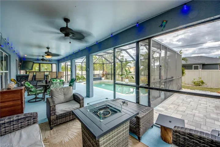 Sunroom with ceiling fan and a pool
