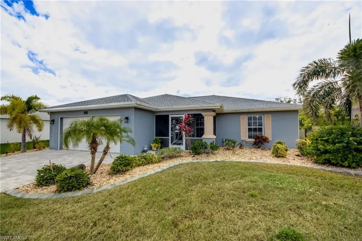 Ranch-style home with a front yard and a garage