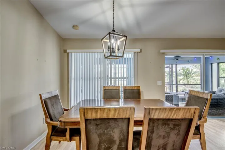 Dining area with light hardwood / wood-style flooring and a notable chandelier