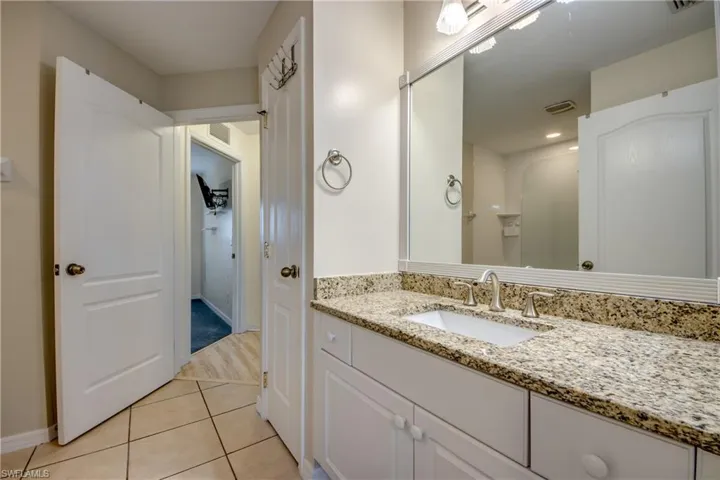 Bathroom with tile patterned flooring and vanity