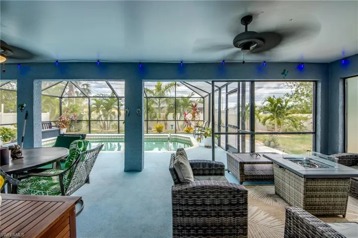 Sunroom / solarium with ceiling fan and a swimming pool