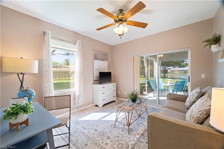 Living room featuring a ceiling fan and baseboards