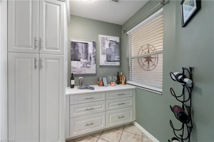 Bathroom with light tile patterned floors and vanity