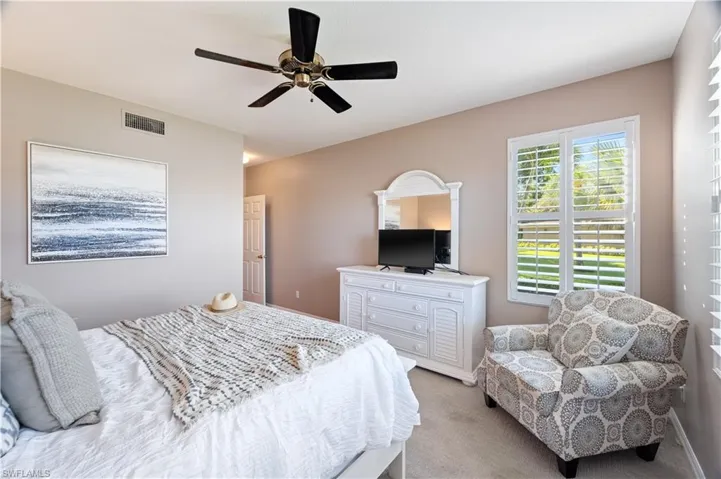 Carpeted bedroom with ceiling fan