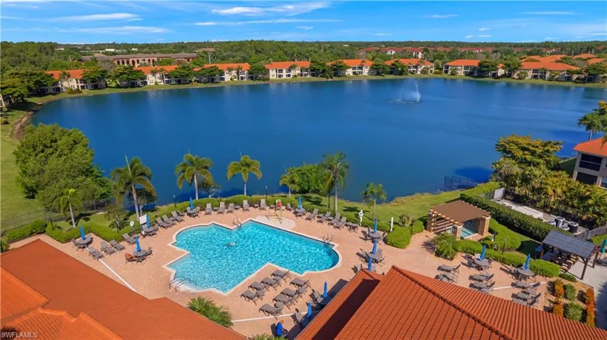 Drone / aerial view of a large body of water and a pool area