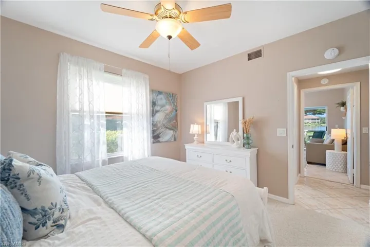 Bedroom with light carpet and ceiling fan