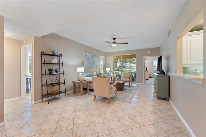 Living room featuring ceiling fan and light tile patterned floors