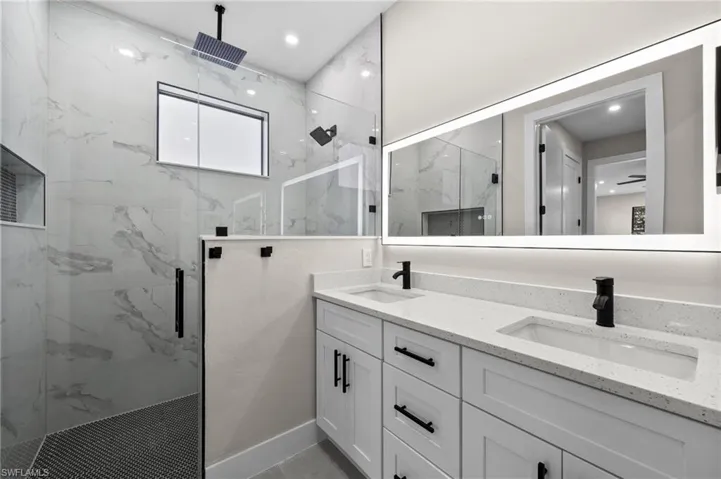 Bathroom featuring vanity and a shower with shower door