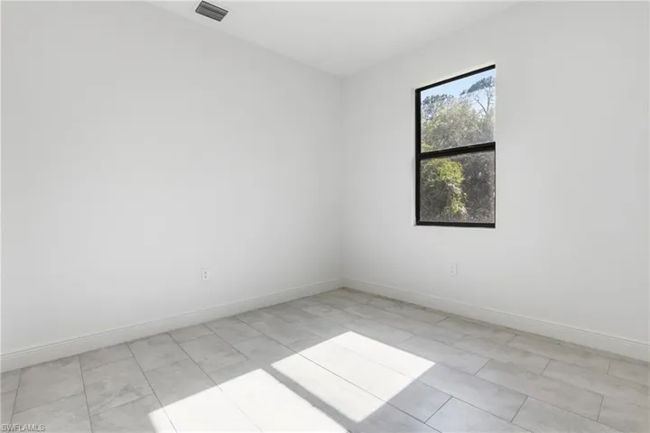 Empty room featuring baseboards