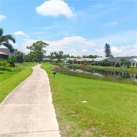 Surrounding community featuring a yard and a water view