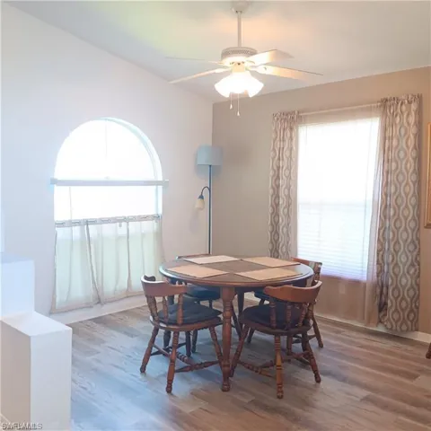 Dining room featuring ceiling fan and hardwood / wood-style flooring