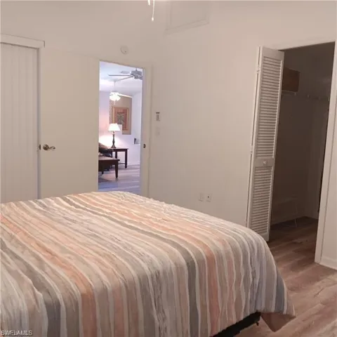 Bedroom with a closet and hardwood / wood-style floors