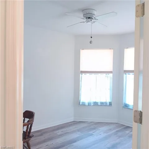 Empty room featuring ceiling fan and hardwood / wood-style flooring
